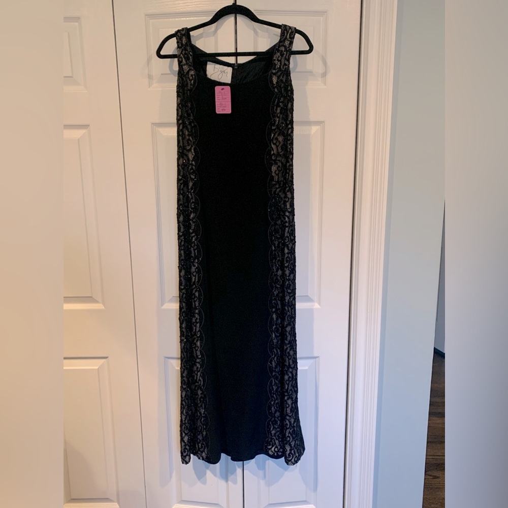 Bizar evening gown in black. Sides are beautifully designed.  Very elegant wear.